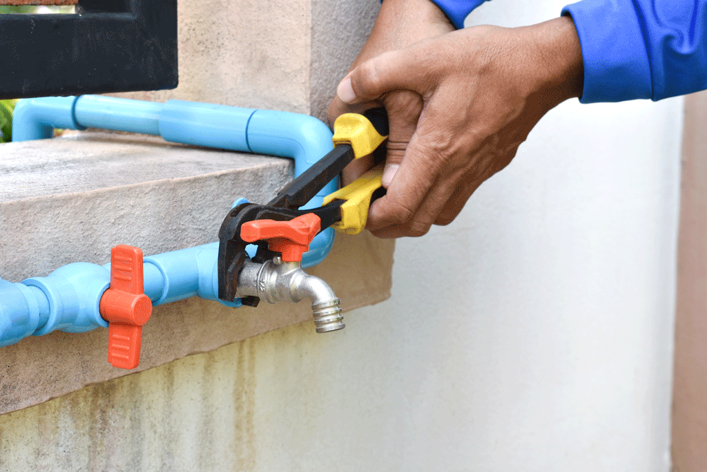man using pliers to tighten water lines Water Line Leak Detection & Repair florence sc quinby sc 