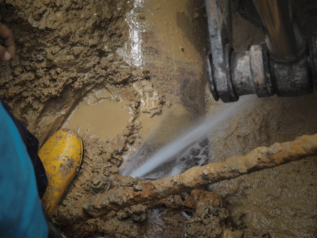 water line broke with a persons foot with mud Water Line Leak Detection & Repair quiby sc florence sc 